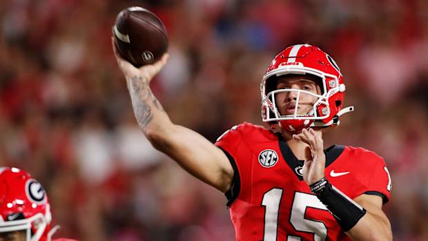 Georgia quarterback Carson Beck (15) throws a touchdown pass to Georgia wide receiver Rara Thomas (5) during the first half of a NCAA college football game against Kentucky in Athens, Ga., on Saturday, Oct. 7, 2023.  